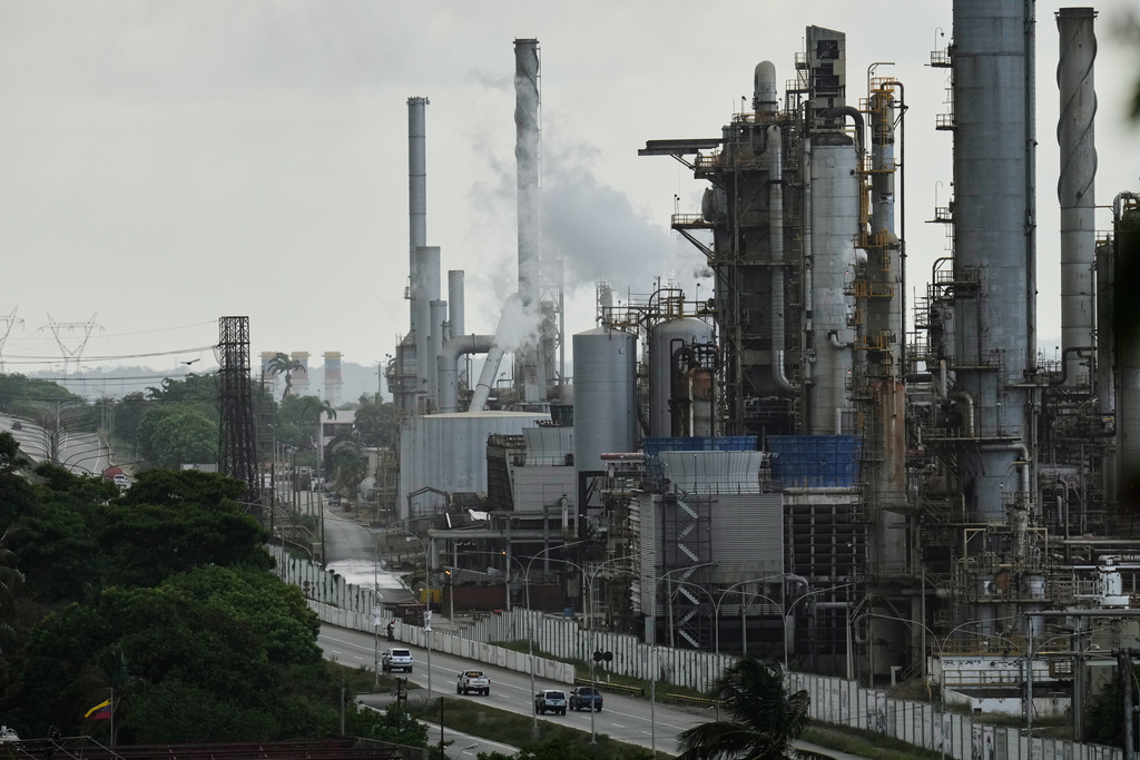 Vehicles drive past the El Palito refinery in Puerto Cabello, Venezuela, Sunday, Dec. 21, 2025. 