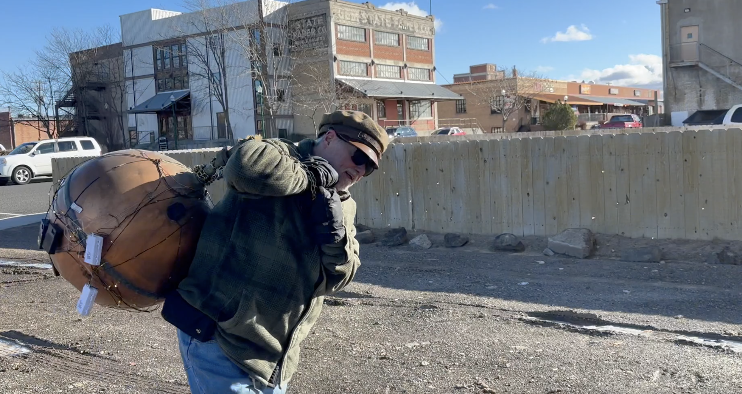 Dave Woodhead carries a big copper ball to the historic grain silos in Twin Falls on Monday, Dec 30, 2024