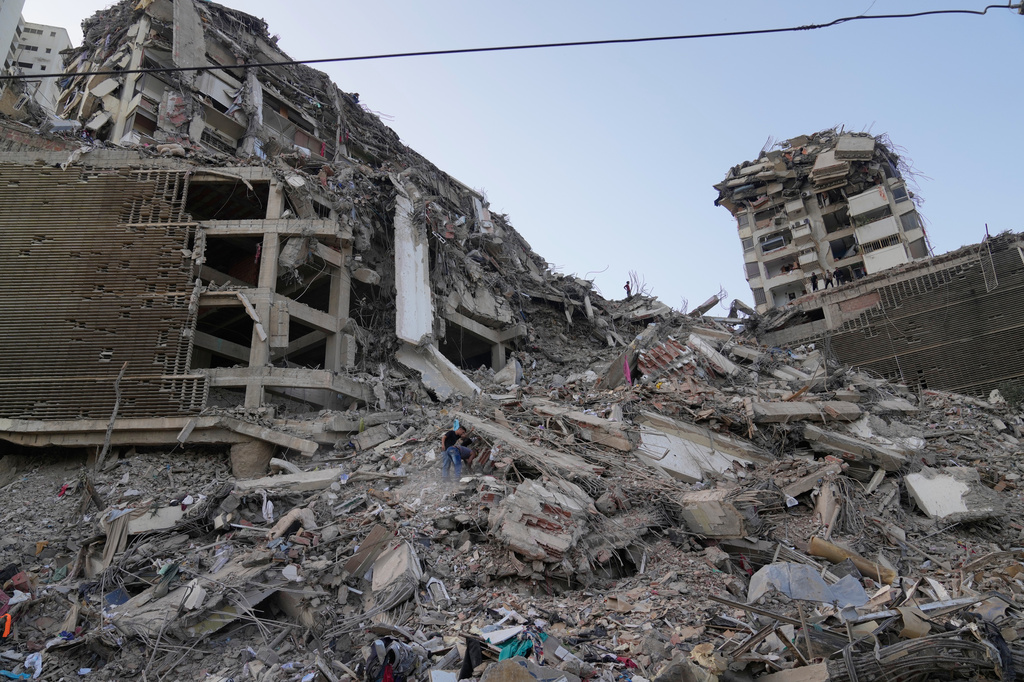 Residents search through the rubble two days after an earthquake struck La Guaira, Venezuela, Friday, June 26, 2026. 