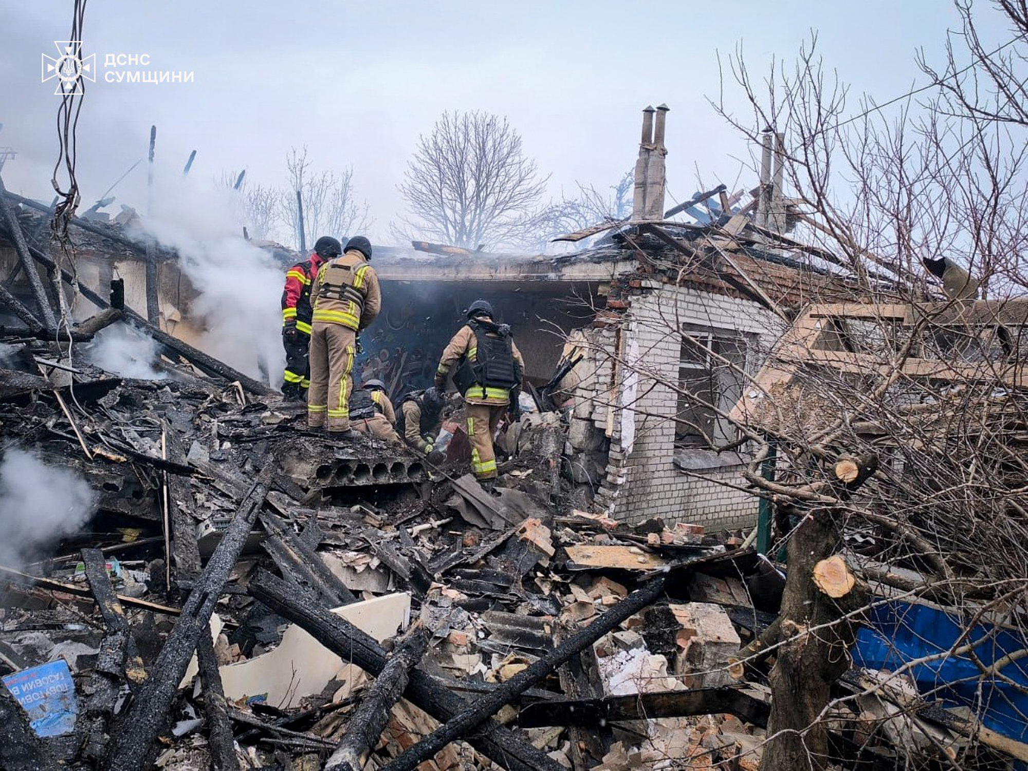 In this photo provided by the Ukrainian Emergency Service, firefighters put out the fire in private houses following a Russian air attack in Sumy region, Ukraine, Tuesday, Feb. 17, 2026. 