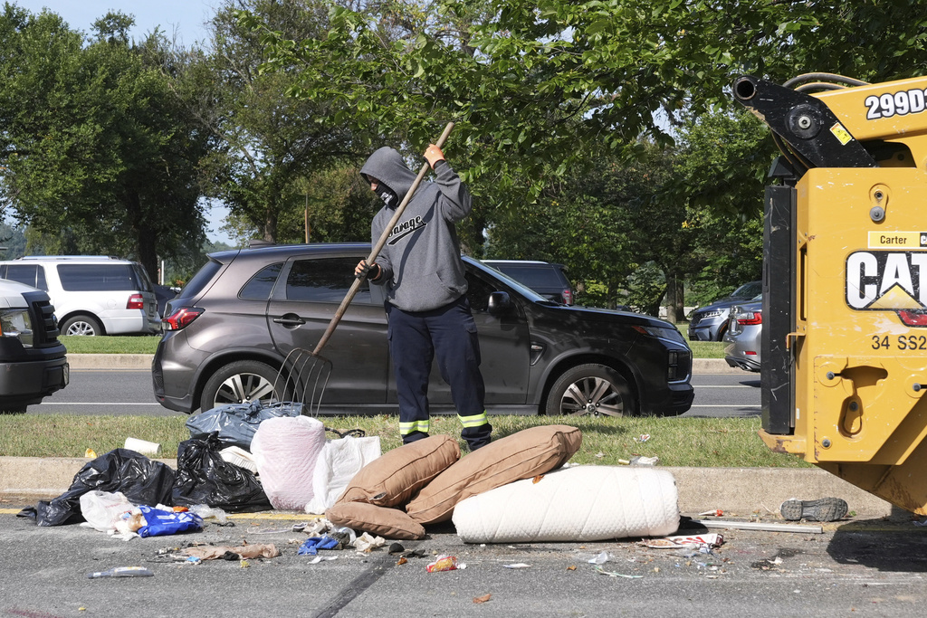 Items belonging to the homeless are removed from a tent encampment in Washington, D.C.