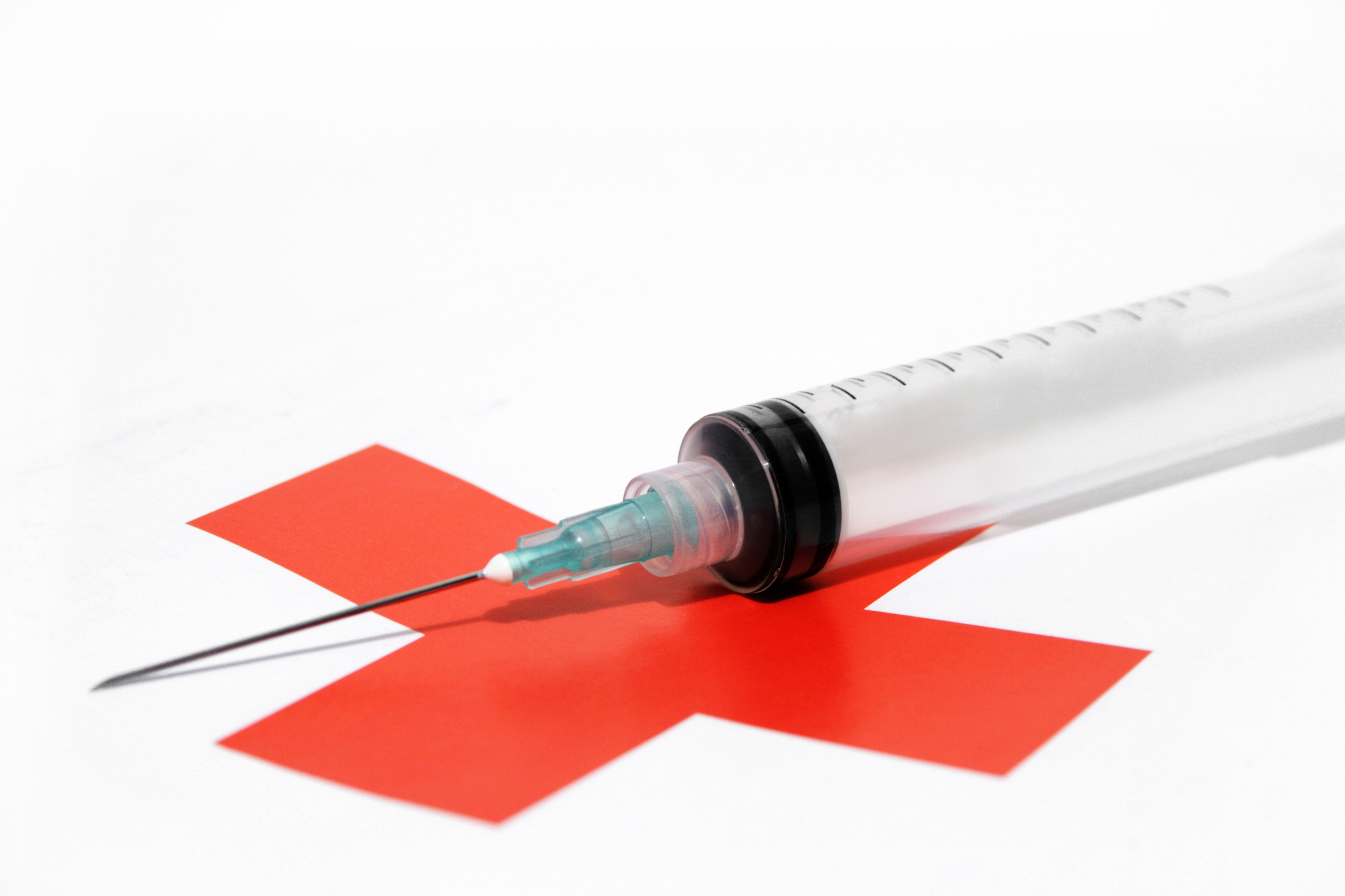 Syringe and red cross