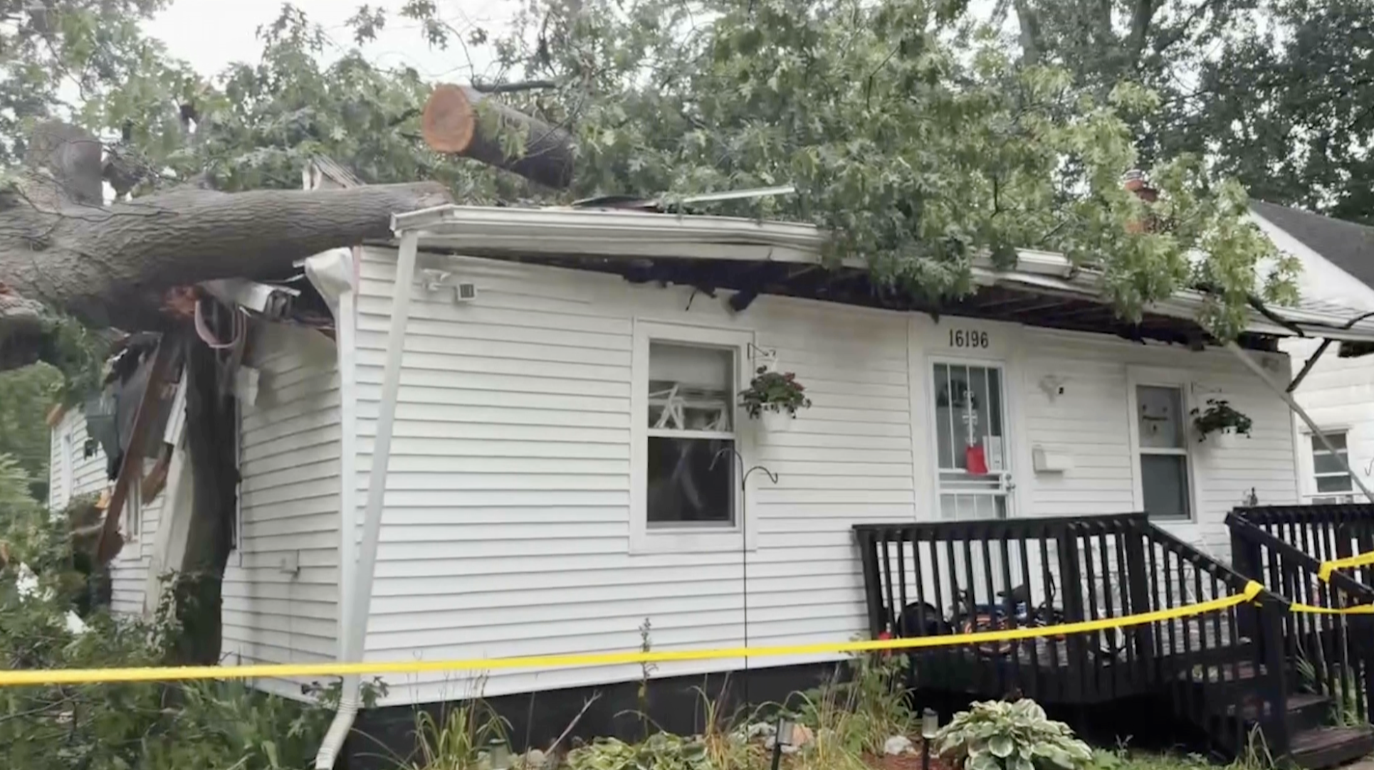A tree falls onto a house. 