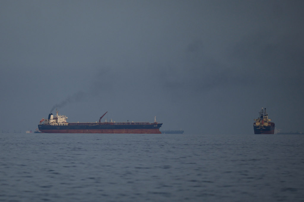 Oil tankers and cargo ships line up in the Strait of Hormuz as seen from Khor Fakkan, United Arab Emirates, Wednesday, March 11, 2026.
