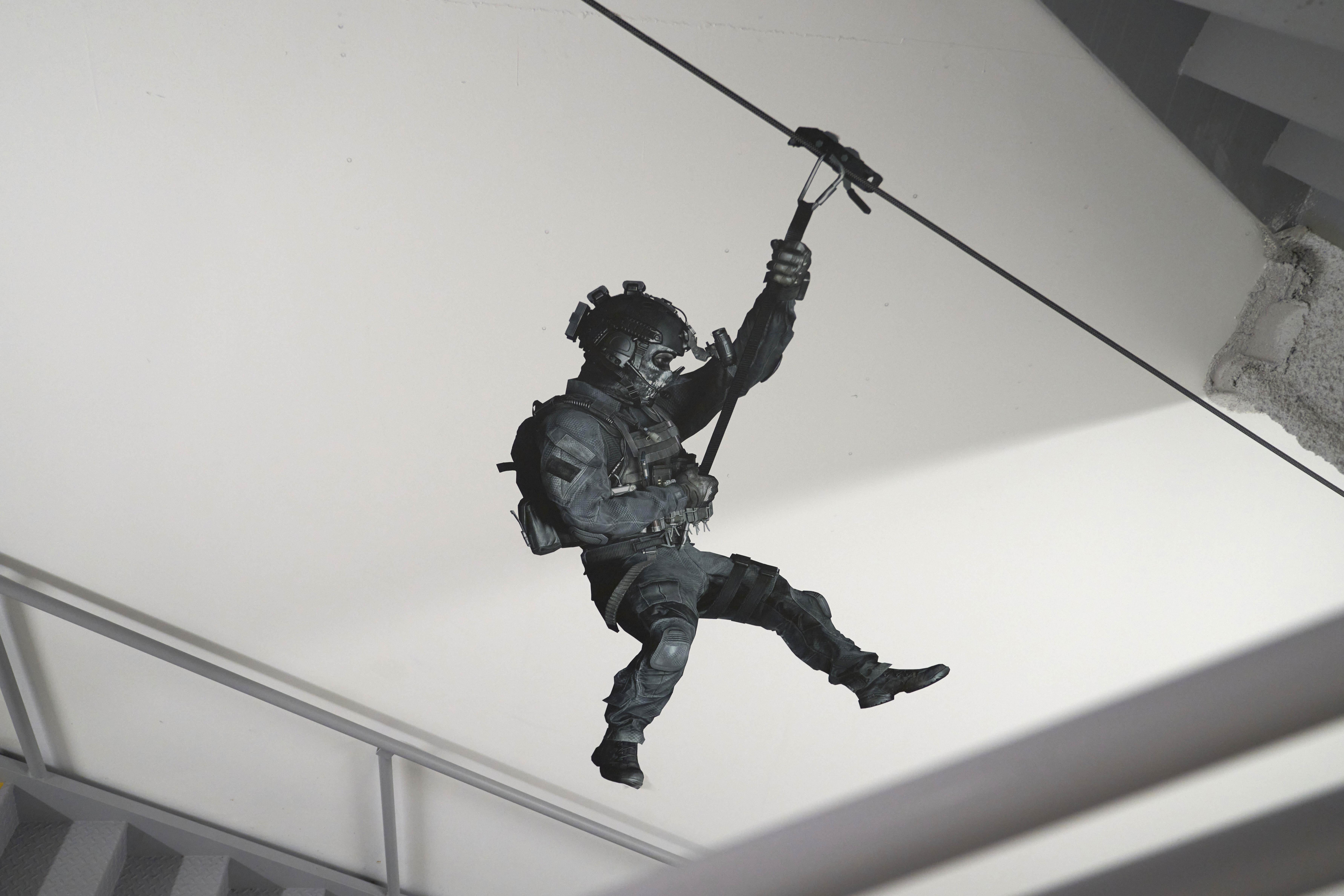 A Call of Duty character hangs on the wall in a stairwell on Friday, Oct. 21, 2022, at Activision Blizzard, Infinity Ward Division, in Woodland Hills, Calif. The release of Call of Duty: Modern Warfare 2 continues a nearly two-decade run for California-based Activision Blizzard's wildly popular military shooting game franchise. New installments of the game can rival Hollywood's biggest blockbusters in how much they earn on their opening weekend. But the battle this time is also happening off-screen as Call of Duty is at the center of a corporate tug-of-war between Microsoft’s Xbox and Sony’s PlayStation over Microsoft's pending $69 billion purchase of Activision Blizzard.(AP Photo/Allison Dinner)


