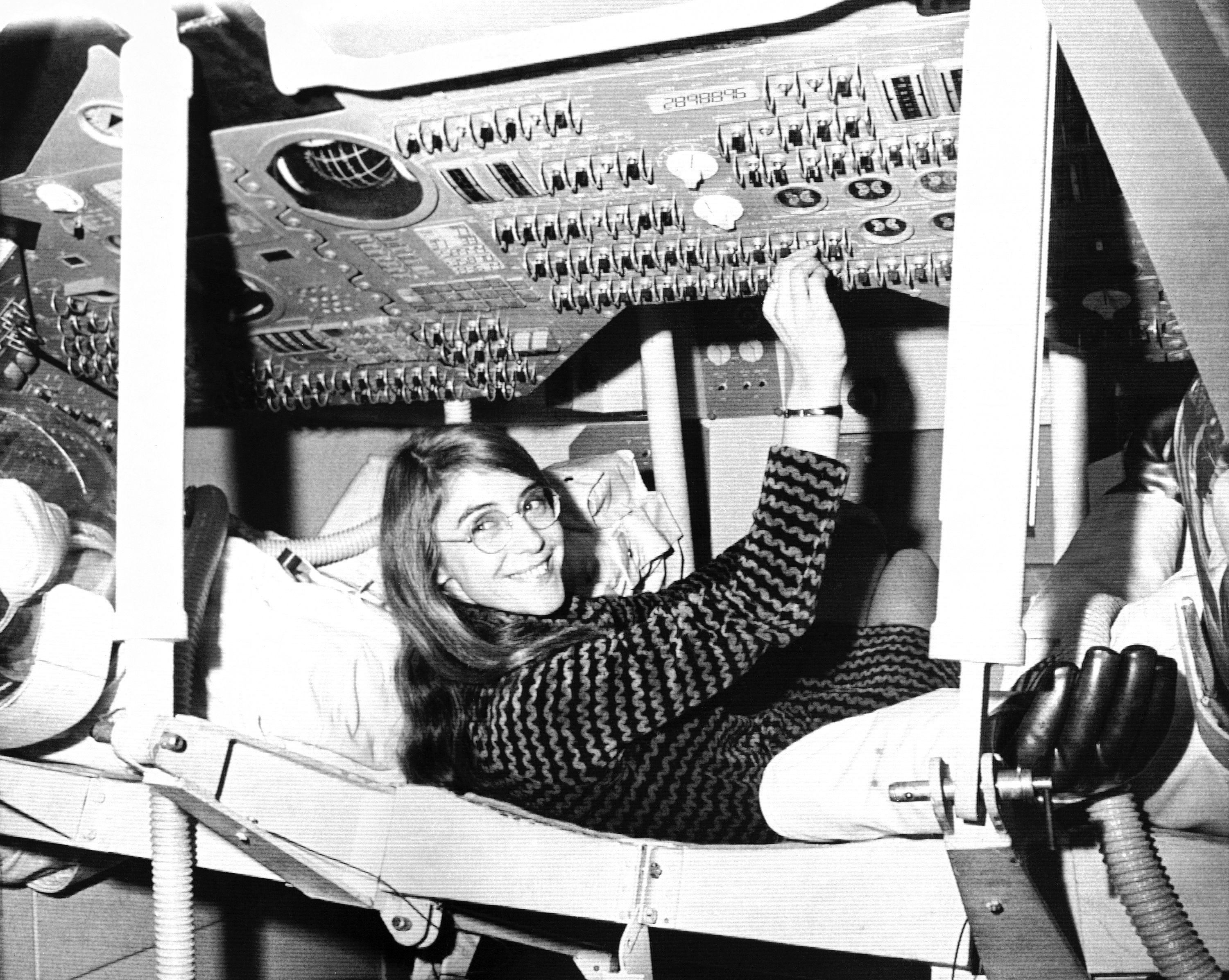 Margaret Hamilton sits in mock-up of an Apollo command module on display at the Cambridge school, November 25, 1969, where she headed the group that programmed the Intrepid spacecraft's pinpoint landing on the moon.