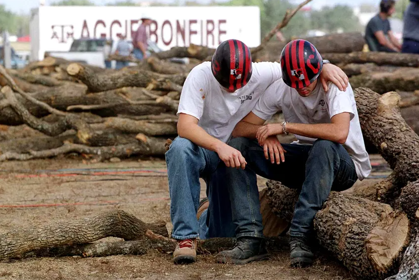 Texas A&M students mourn the loss of fellow students after a bonfire log structure collapsed on Nov. 18, 1999, in College Station, killing 12. The bonfire, made of thousands of logs, was a longtime annual tradition ahead of the school's football game against the University of Texas at Austin.