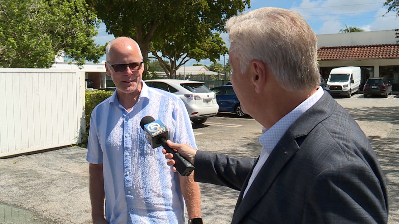 WPTV reporter Matt Sczesny talks to a resident about home insurance costs in Florida.