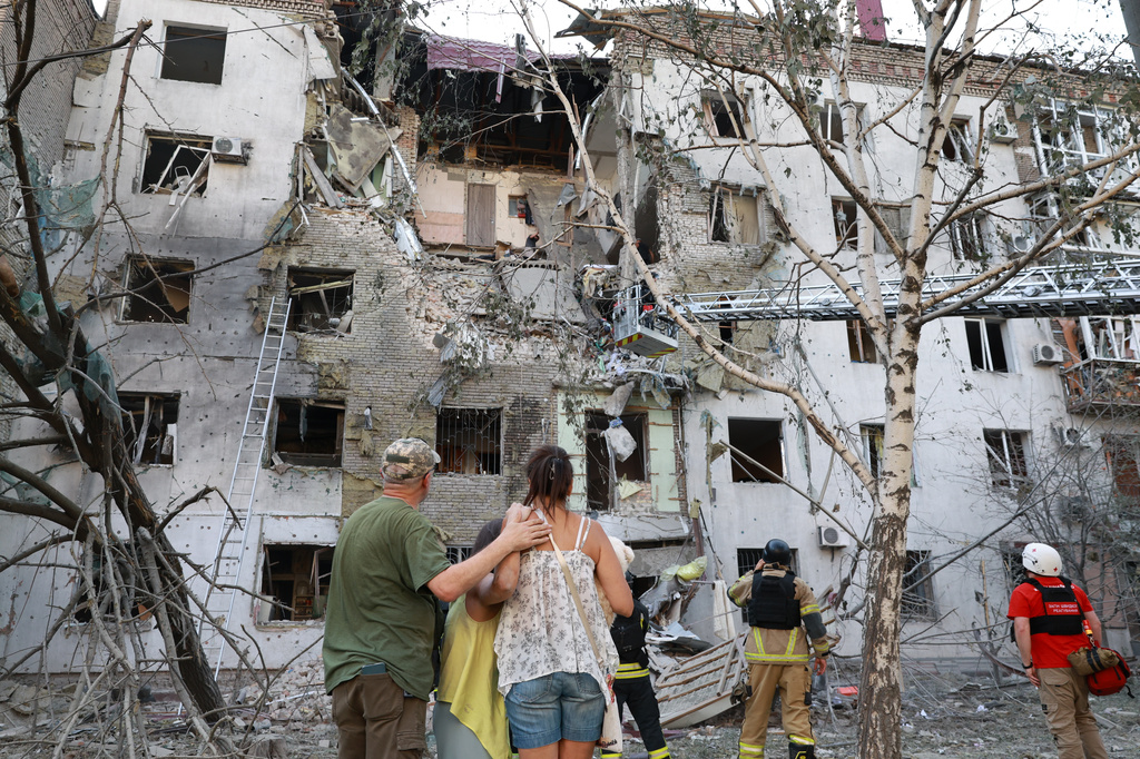 Residents look at their ruined home following a Russian air guided bomb strike in Zaporizhzhia, Ukraine, Sunday, July 19, 2026.