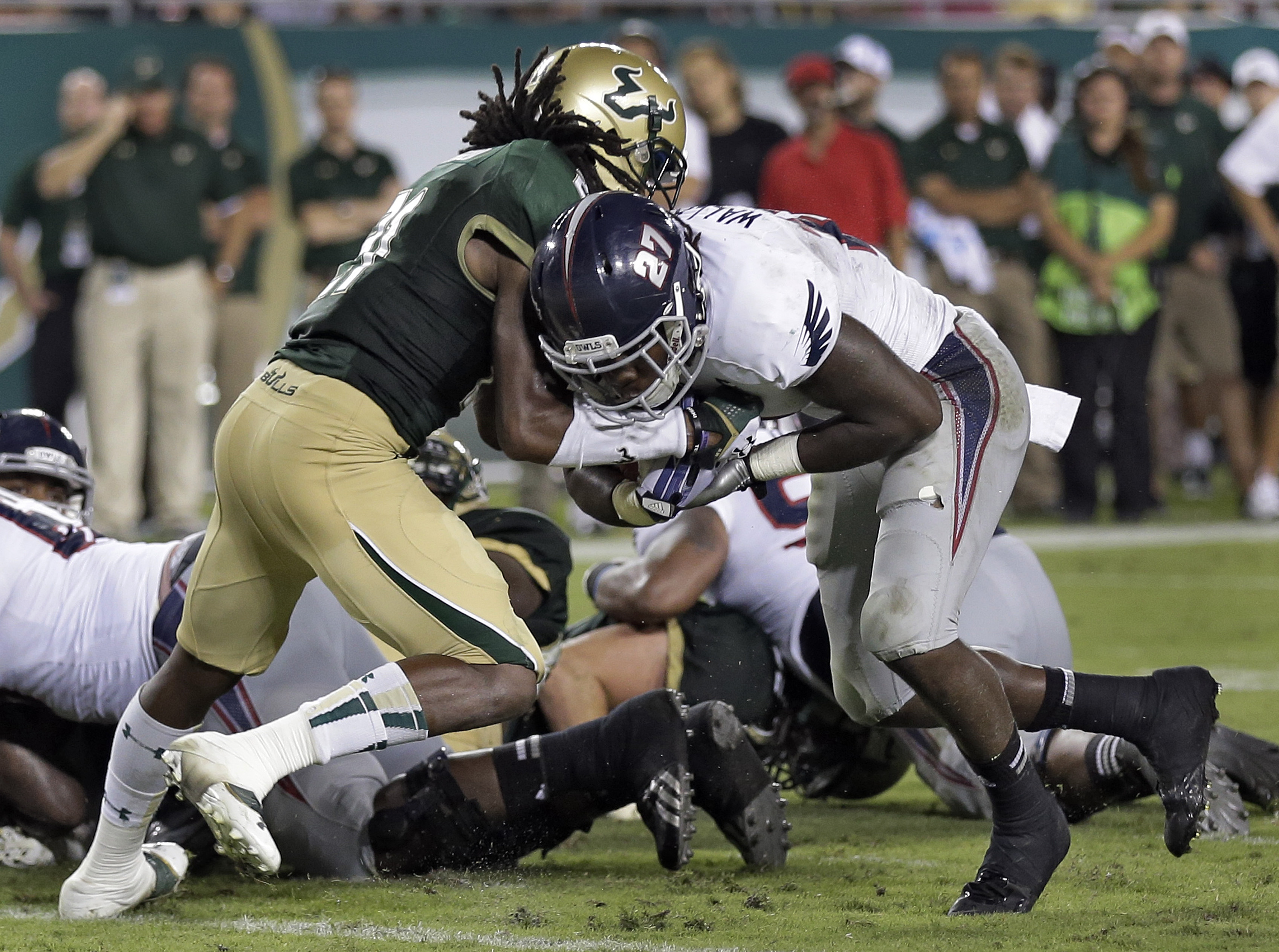 FAU Owls running back Jonathan Wallace pushes USF Bulls cornerback Torrel Saffold into end zone to score TD in 2013