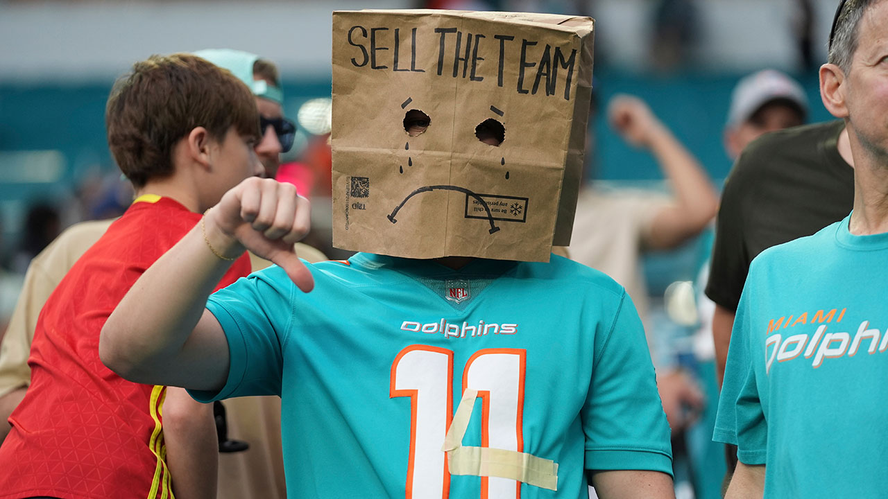 A fan shows his frustration with the Miami Dolphins following an NFL football game against the Cincinnati Bengals, Sunday, Dec. 21, 2025, in Miami Gardens, Fla. 