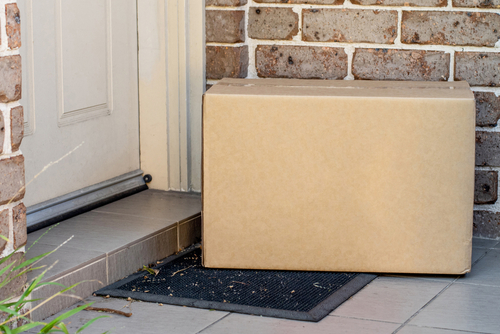 Stock image of a box delivered to a person's porch.