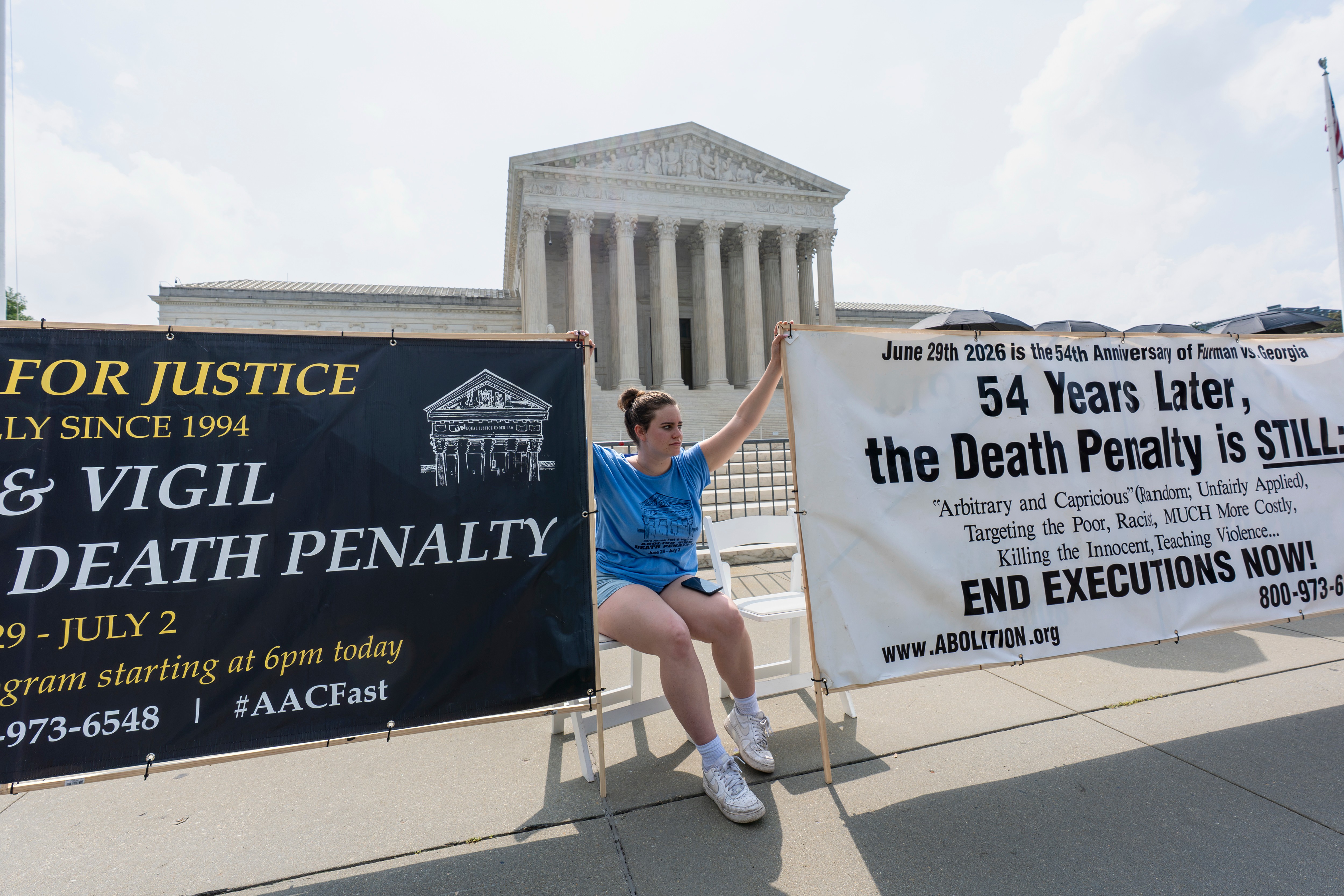 Activists and demonstrators wait outside the Supreme Court for the Justices to release opinions, in Washington, Monday, June 29, 2026.