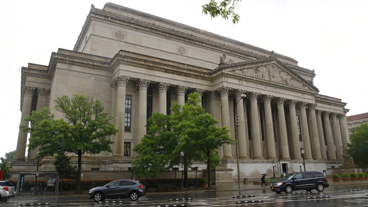 Traffic passes by the National Archives building.