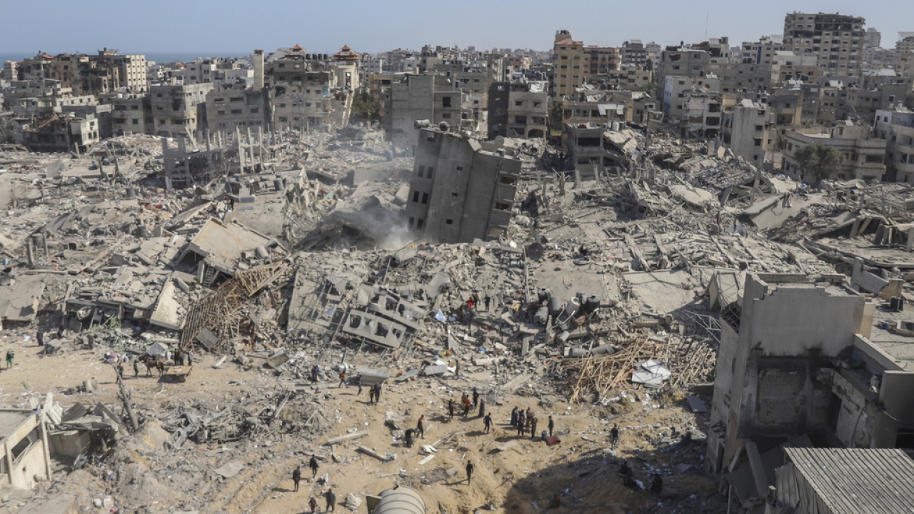 Palestinians walk through the destruction left by the Israeli air and ground offensive on the Gaza Strip.