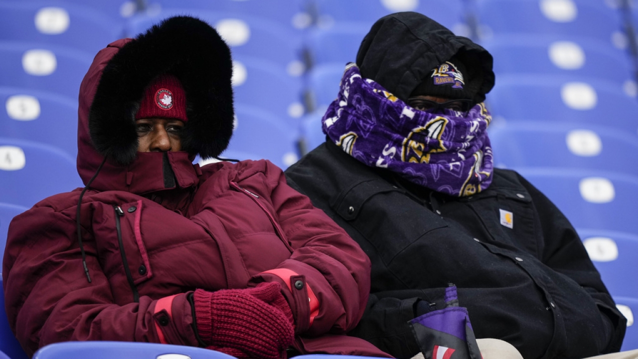 Fans watch teams warm up before an NFL playoff game between the Baltimore Ravens and the Houston Texans.