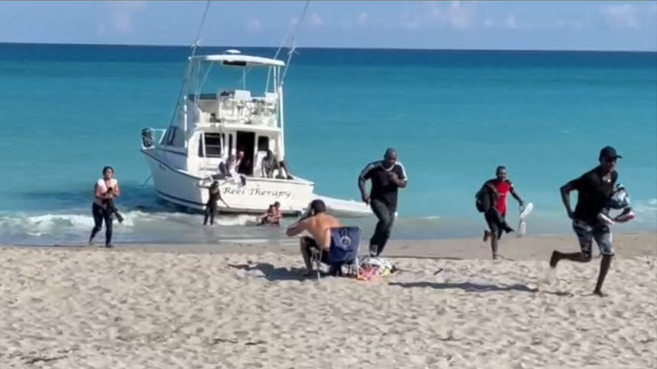Migrants run ashore on beach in Jupiter, Dec. 12, 2021