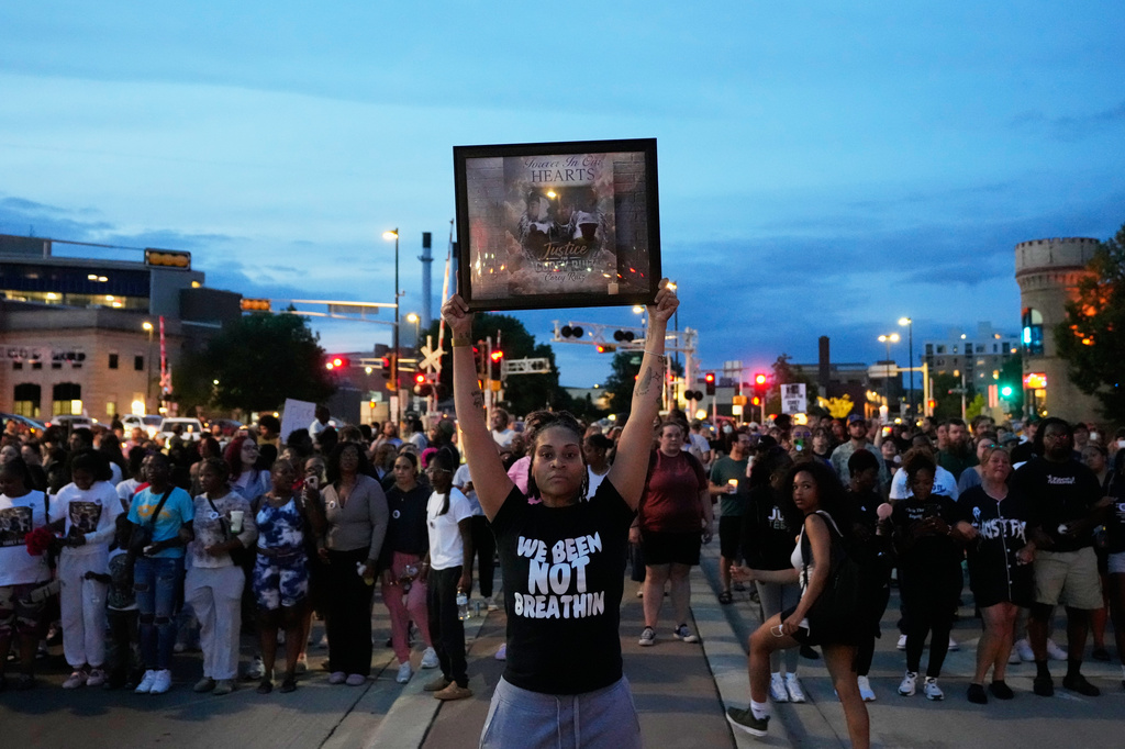 A protester holds a photo of Corey Durell Ruiz as they march Thursday, July 23, 2026, in Madison, Wis., after he was shot and killed by a Madison police officer on Wednesday. 