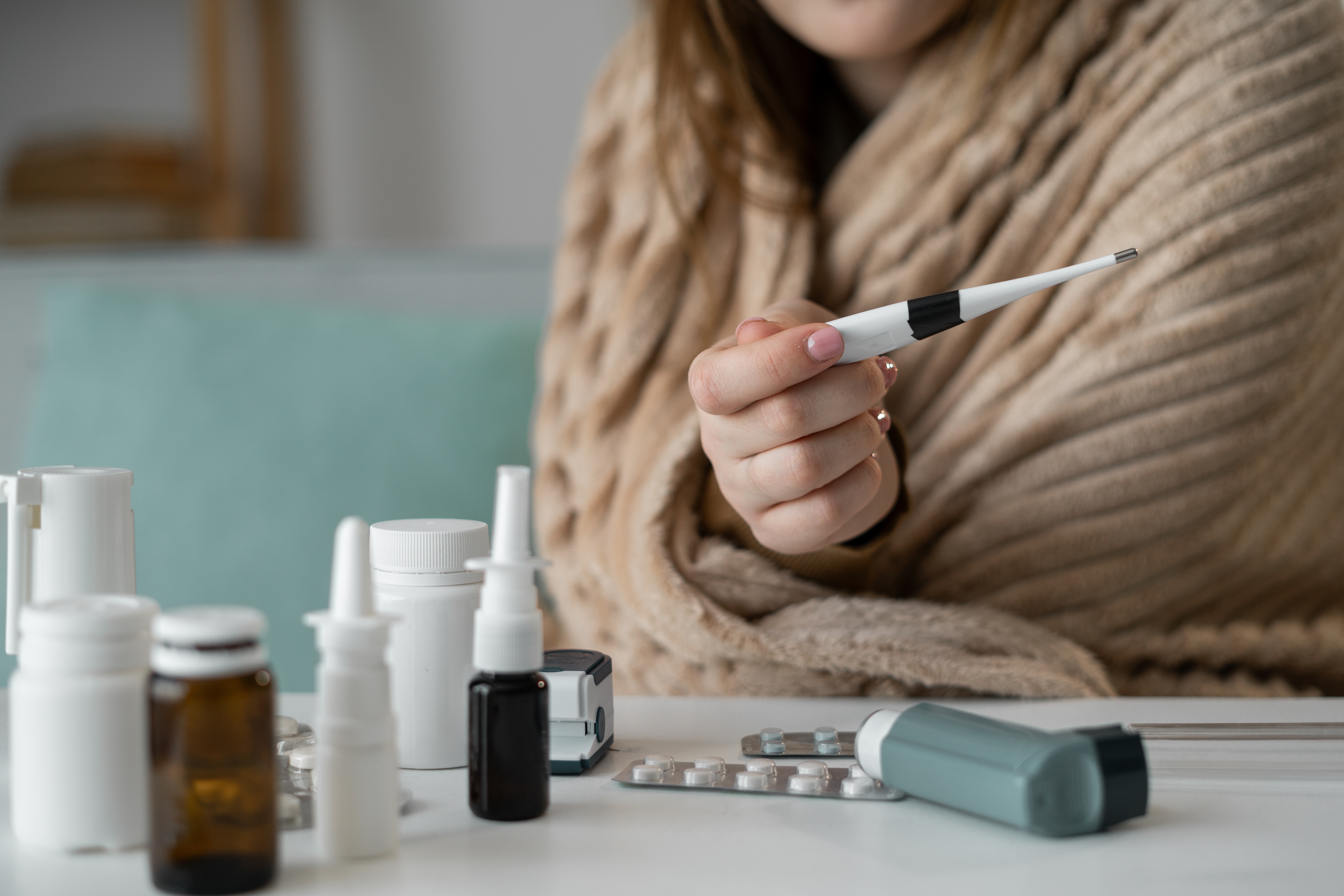 A woman appears with a thermometer.