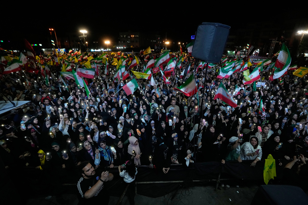 Demonstrators wave Iranian flags and flags of Lebanon's militant Hezbollah group during a pro-government gathering at Islamic Revolution Square in Tehran, Iran, Saturday, May 30, 2026. 