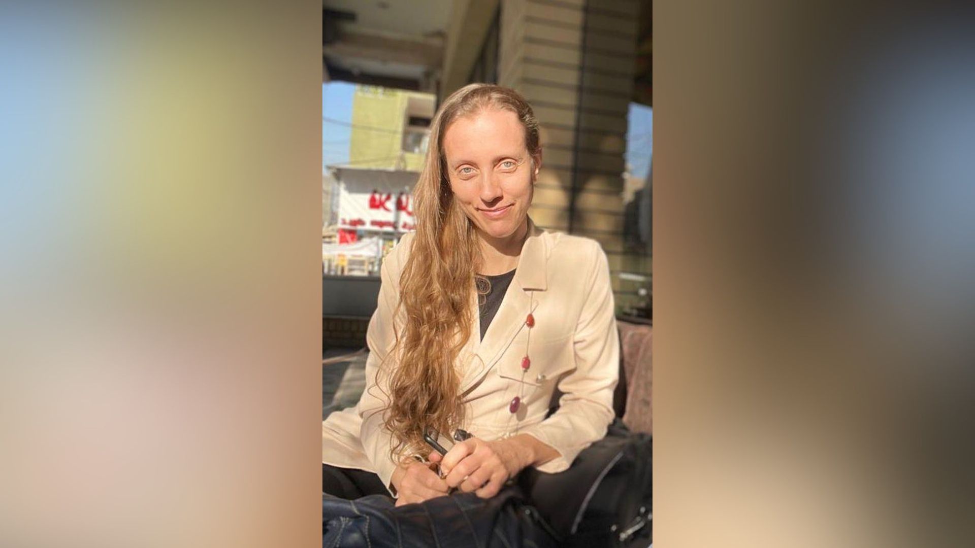 U.S. journalist Shelly Kittleson poses for a cellphone photo in a cafe in Baghdad, Iraq, March 25, 2025. 