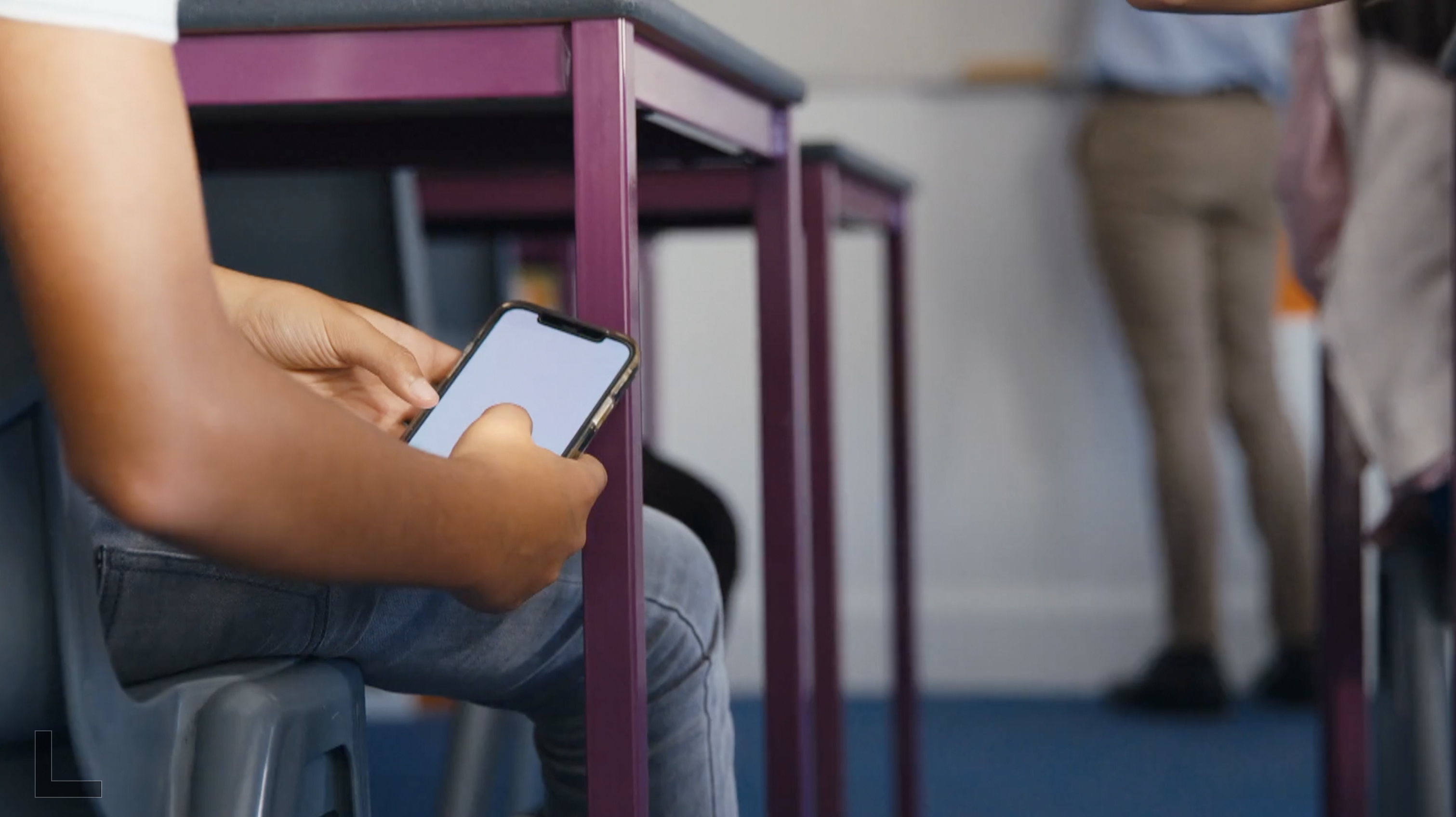 Kid with cellphone in class