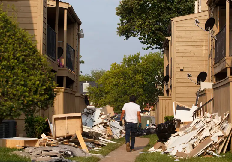 A worker cleans out debris in an apartment complex in the Greenspoint area of Houston on Sept. 6, 2017 after it was flooded by Hurricane Harvey.