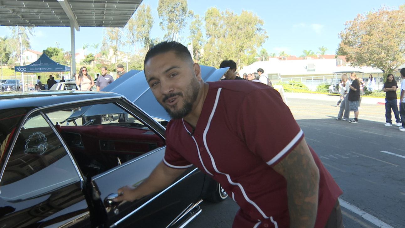 Mario Barajas showing off his lowrider to promote literacy among students. 