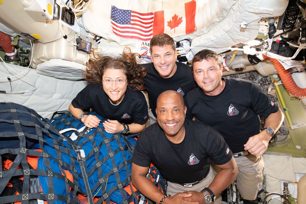 In this image provided by NASA, the Artemis II crew, clockwise from left, Mission Specialist Christina Koch, Mission Specialist Jeremy Hansen, Commander Reid Wiseman, and Pilot Victor Glover, pause for a group photo inside the Orion spacecraft on their way home on Wednesday, April 7, 2026.  