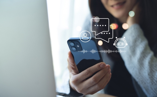 Stock image of a woman looking at a smartphone.