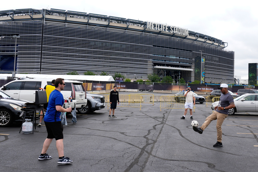 Fans play with a ball outside the Metlife Stadium prior to the Club World Cup final soccer match between Chelsea and PSG in East Rutherford, N.J., Sunday, July 13, 2025. 