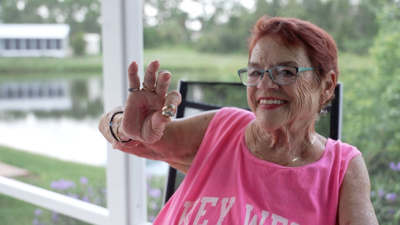Rosie Quaranta holds up her wedding rings — one of the few treasures recovered from the debris after the tornado destroyed her home.