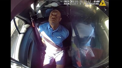Body camera video provided by the Martin County Sheriff's Office shows golfer Tiger Woods in handcuffs in the back of a patrol car on March 27, 2026. 
