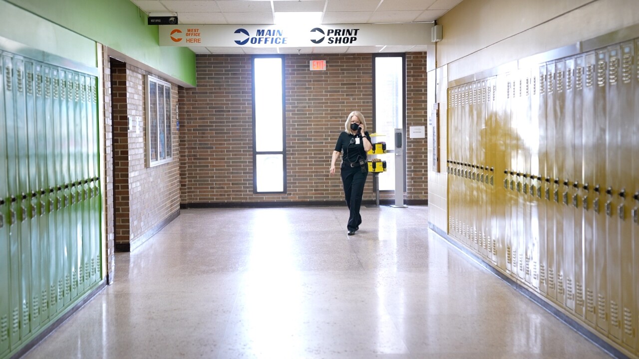 Jan Bidwell walks down a hallway. 