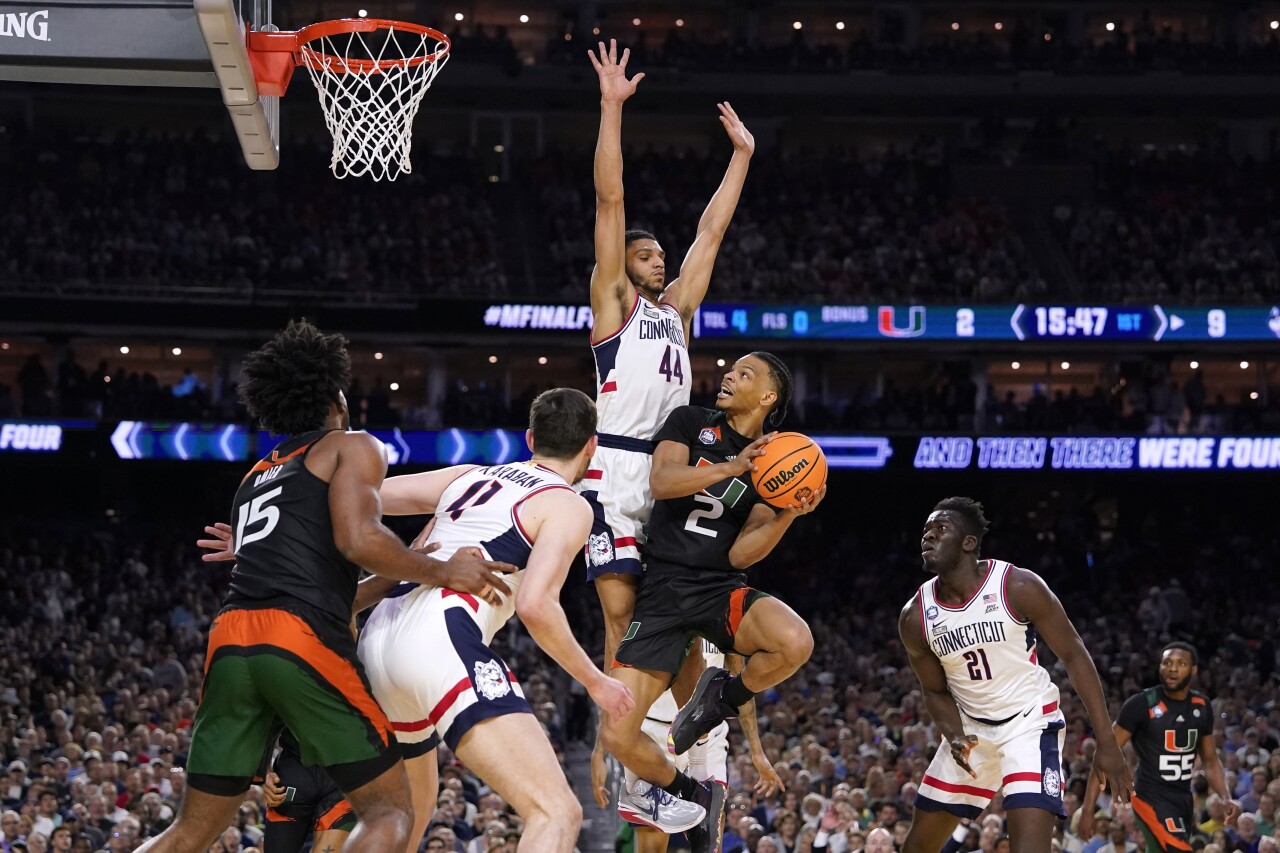 Miami Hurricanes guard Isaiah Wong drives to basket against Connecticut Huskies guard Andre Jackson Jr. in first half of Final Four, April 1, 2023