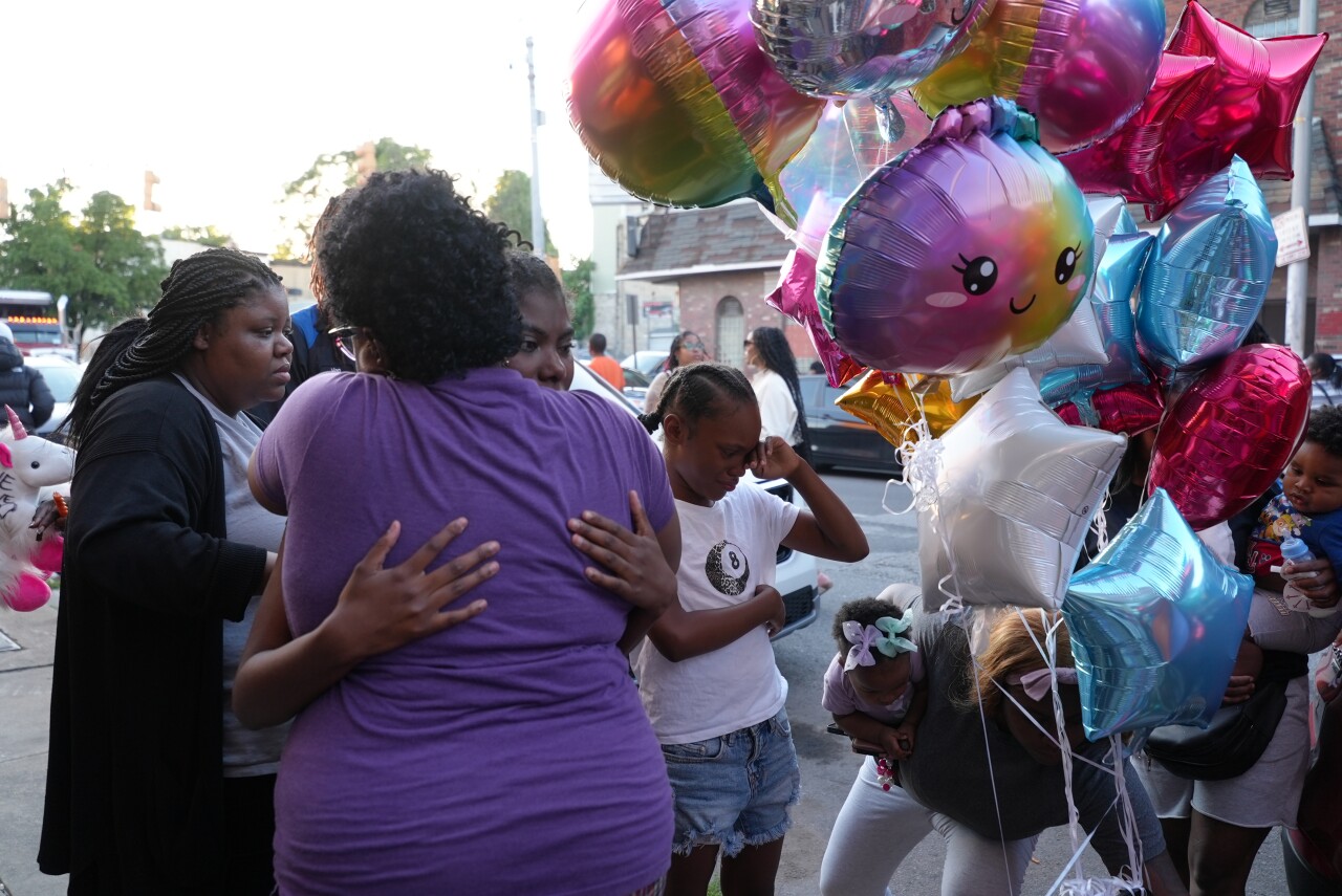 Family members hugging at the memorial