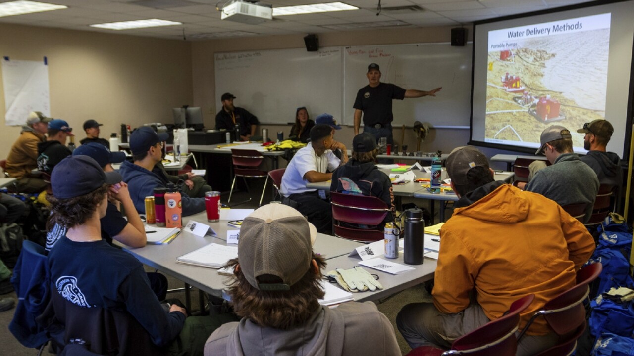Wildfire academy students gather for instruction in a classroom.