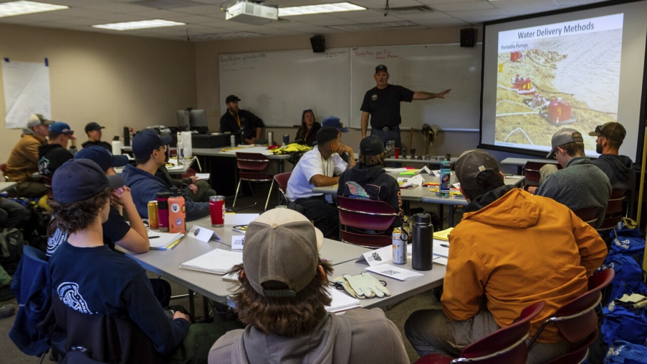 Wildfire academy students gather for instruction in a classroom.