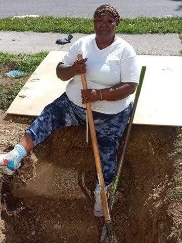 Michelle English poses for a picture taken over the summer when she was digging a ditch.