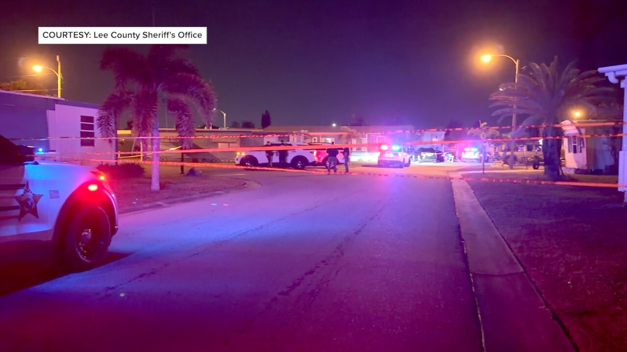 Deputies, crime scene tape, and squad cars at the scene