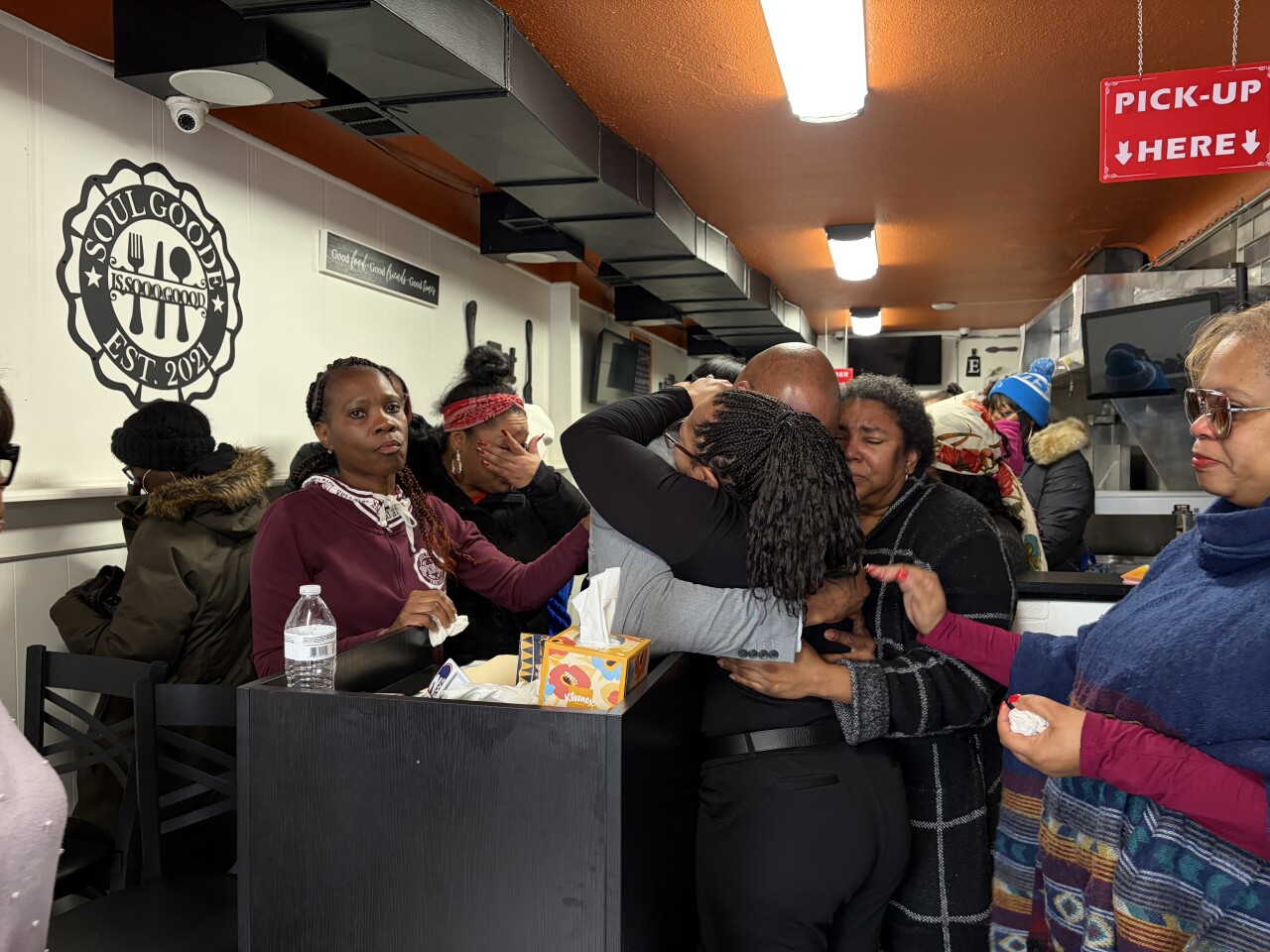 Friends and family comforting one another in the wake of Mucari Finley's death