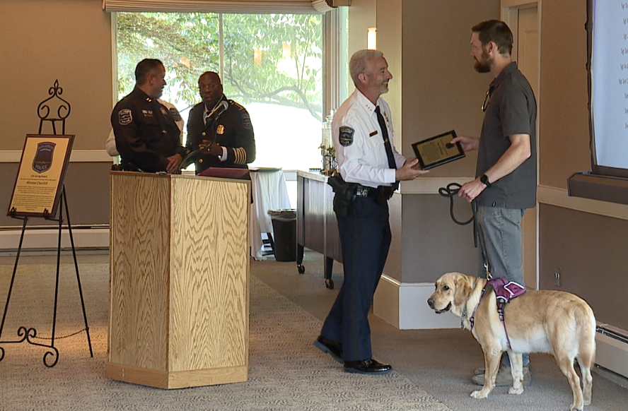 Ben Osenbaugh and his dog Dolly being recognized by the Ann Arbor Police Department