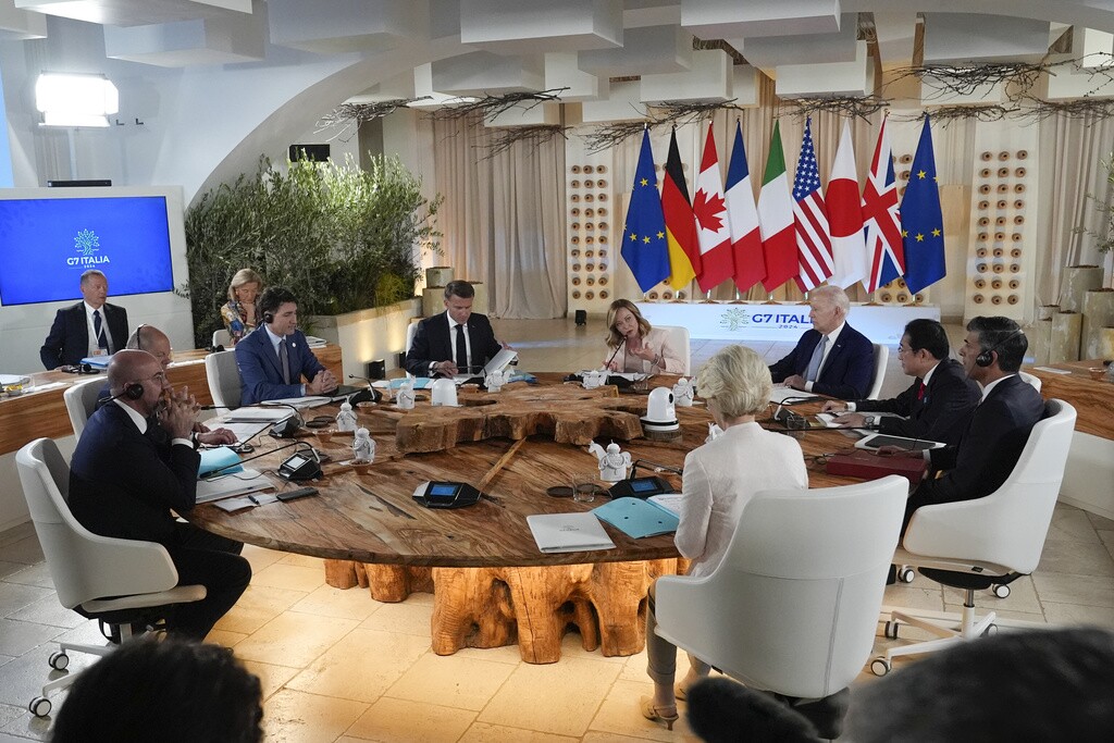 Top leaders of the Group of Seven nations sit around a table for a working session at the G7 summit in Italy