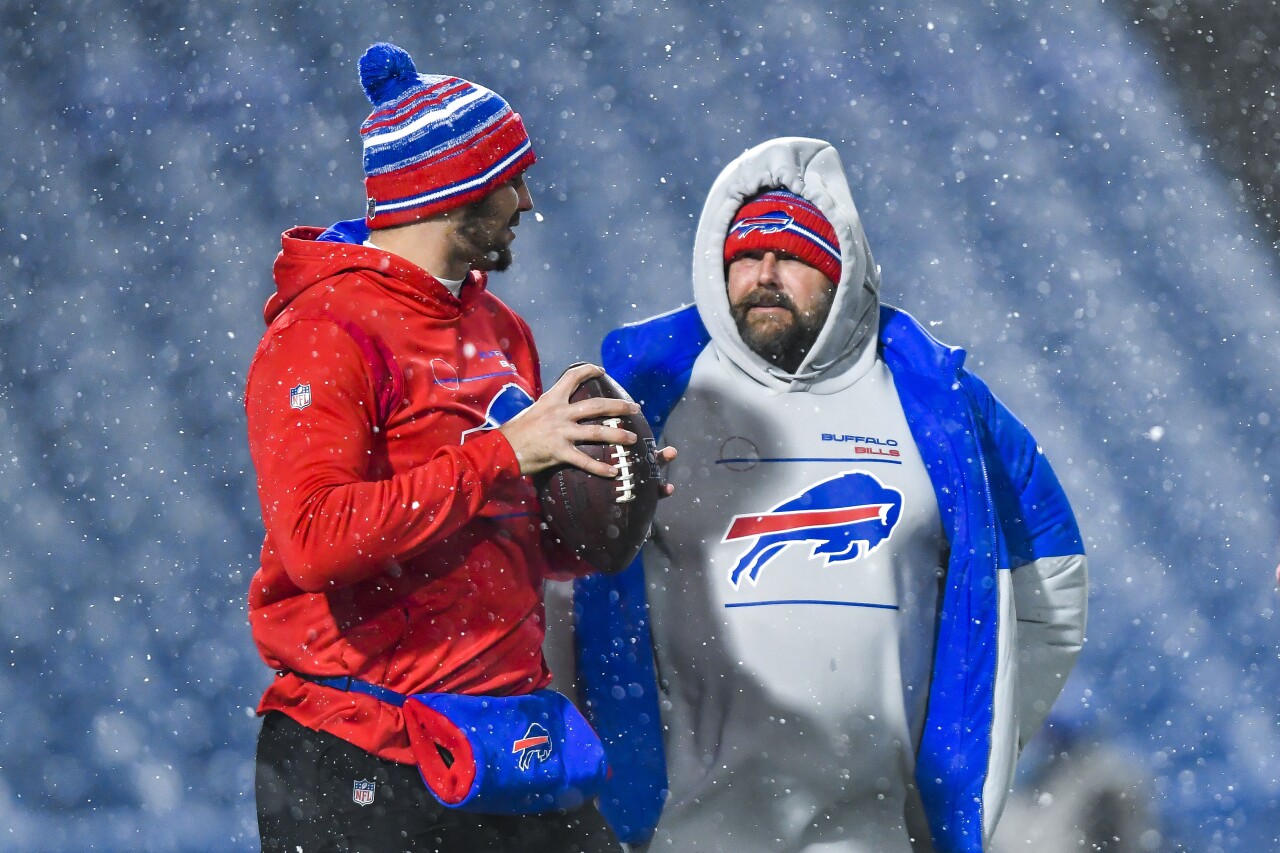 Buffalo Bills offensive coordinator Brian Daboll talks to QB Josh Allen before snow game vs. New England Patriots, Dec. 6, 2021