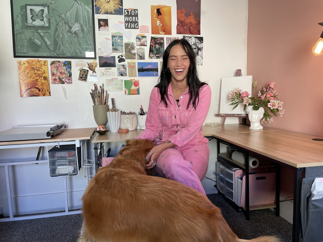 Paige Rochefort in her at-home studio with her pup Henry by her side