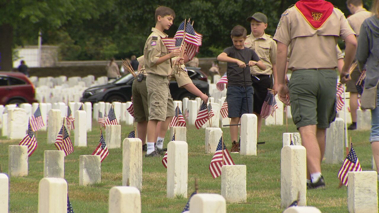 Scouts place flags for Memorial Day