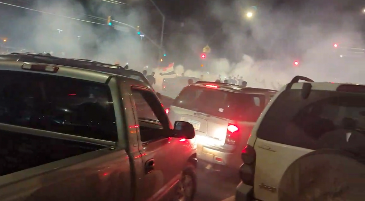Cars spin out and fill the air with exhaust during a street "takeover" at Pantano and Escalante.