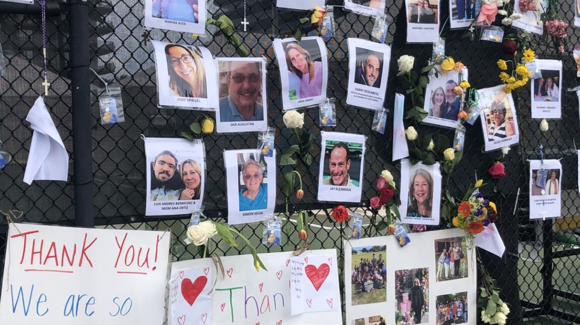 A wall shows photos of dozens of missing people from the Champlain Towers condo collapse on June 28, 2021.jpg