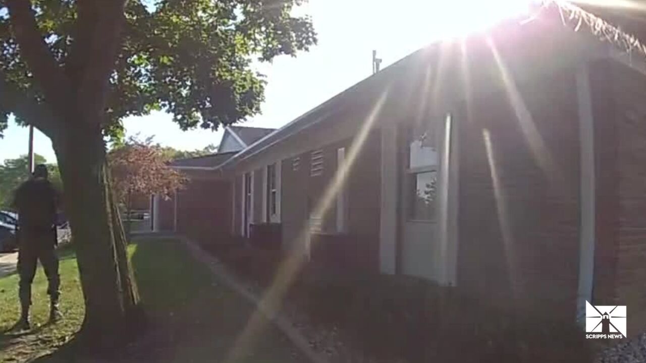 Officers confront the man who attacked an LDS church in Michigan. 