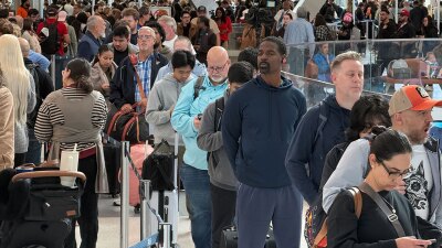 Travelers wait in long security lines at George Bush Intercontinental Airport, Monday, Nov. 3, 2025, in Houston. (AP Photo Lekan Oyekanmi)